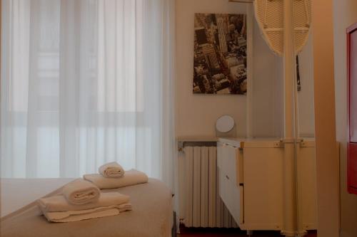 a bedroom with a bed with towels on it at Italianway Easy - Dogana 3 in Milan