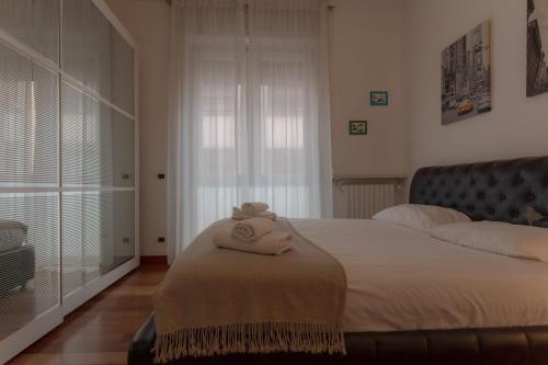 a bedroom with a bed with two towels on it at Italianway Easy - Dogana 3 in Milan