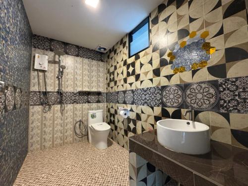 a bathroom with a sink and a toilet at Khaolak Nature House in Khao Lak