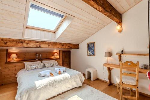 a bedroom with a large bed and a window at Ecrin des anges in Vacheresse