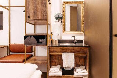 a bathroom with a sink and a mirror at Hotel Palais26 in Villach
