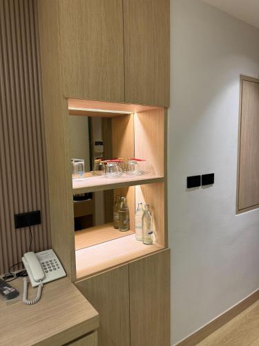 a office cubicle with a desk with a phone at Viva Hotel Songkhla in Songkhla