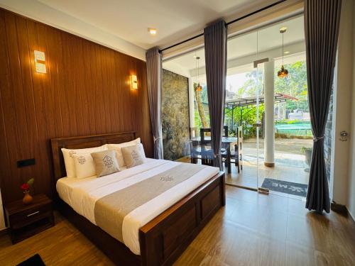 a bedroom with a bed and a sliding glass door at Home Away Ella in Ella
