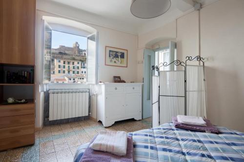 a bedroom with a bed and a window at Beautiful view apartment Riomaggiore, Cinque Terre in Riomaggiore