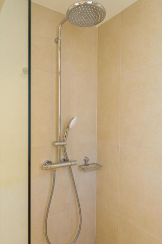 a shower with a shower head in a bathroom at Villa Artemis 4 - Etheras Properties in Kythira