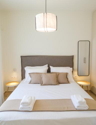 a bedroom with a white bed with two towels on it at Villa Artemis 4 - Etheras Properties in Kythira