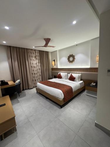 a hotel room with a bed and a desk at Divine OAK Stay in Narendranagar
