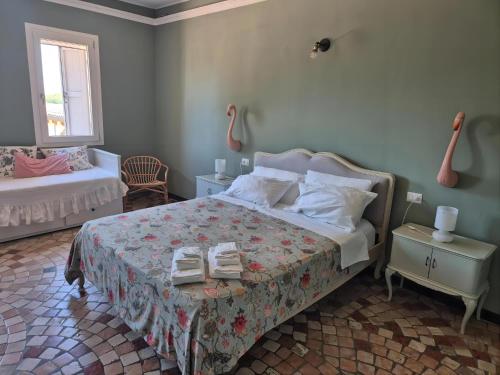 a bedroom with a bed and a table with towels on it at Al Civico 73 in Carpi