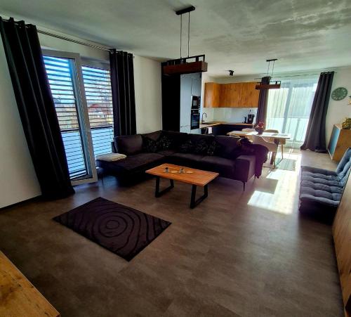 a living room with a couch and a table at Apartments Javor in Veľký Slavkov