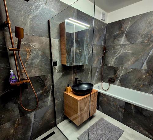 a bathroom with a sink and a shower at Apartments Javor in Veľký Slavkov