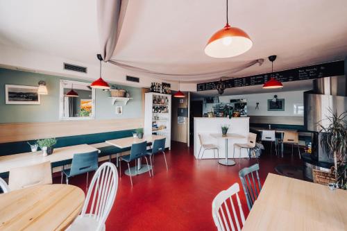 a restaurant with tables and chairs and a counter at Penzion Rak Wellness in Černá v Pošumaví