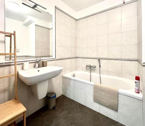 a white bathroom with a sink and a bath tub at Il Rifugio di Boccadasse in Genoa
