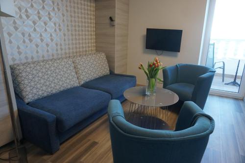 a living room with a couch and two chairs and a table at Hotel Fiesa in Piran