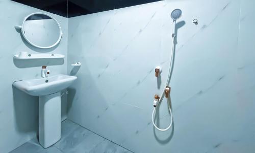 a bathroom with a shower and a sink and a mirror at Dan Sewana in Nochchiyagama
