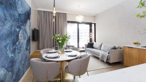 a living room with a table and chairs at Sol Marina 231 in Wiślinka