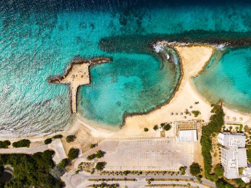 an aerial view of a beach and the ocean at Parasasa Hotel Curacao in Willemstad
