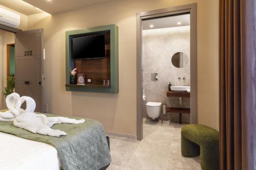 a hotel room with a bed and a bathroom at La Piazzetta Sea Rooms in Balestrate