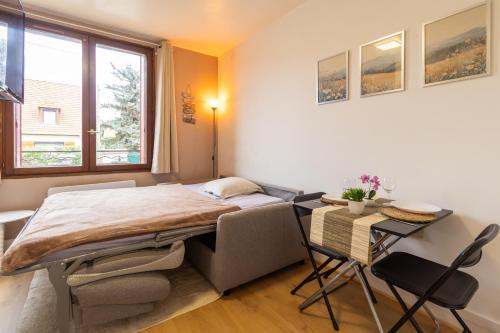 a bedroom with a bed and a table with chairs at Studio à Champigny sur marne in Champigny-sur-Marne