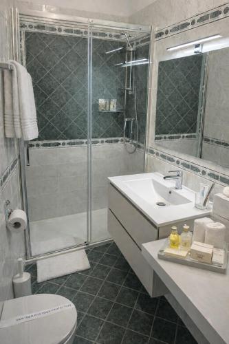 a bathroom with a shower and a sink and a toilet at Hotel SoleMare in Diano Marina