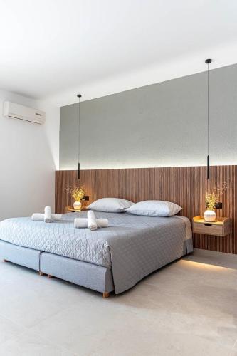a bedroom with a large bed with two lamps on it at Elysian Studio A2 in Karpathos
