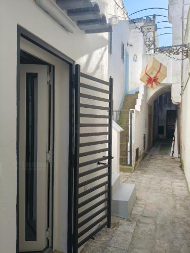 an alley with an open gate in a building at La casa della nonna by LoveSud in Castrignano del Capo