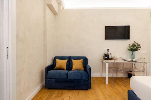 a blue couch with two pillows in a living room at The Place 217 in Rome