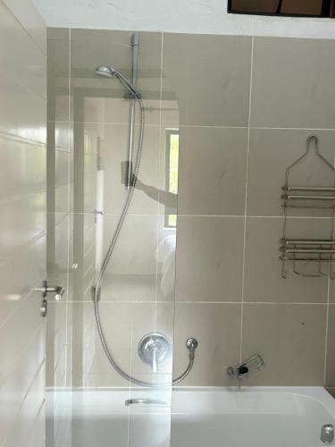 a shower in a bathroom with a glass door at The golf estate gateway in Roodepoort