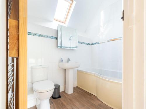 a bathroom with a toilet and a sink and a tub at 2 Bed in Crediton oc-72791 in Coldridge