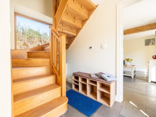 a staircase in a house with wooden stairs and a blue rug at 2 Bed in Crediton oc-72791 in Coldridge
