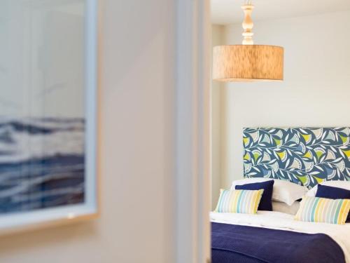 a bedroom with a bed and a lamp and a picture at 3 Bed in Bideford oc-52079 in Westward Ho