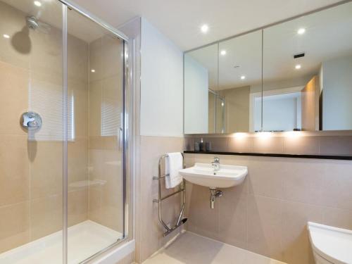 a bathroom with a shower and a sink and a mirror at 3 Bed in Bideford oc-52079 in Westward Ho