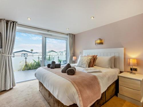 a bedroom with a large bed and a large window at 2 Bed in Bideford oc-65074 in Northam