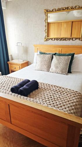 a bedroom with a large bed with a wooden headboard at Luxury Beachfront Apartment Brighton Centre in Brighton & Hove
