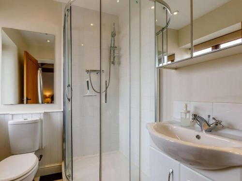 a bathroom with a sink and a glass shower at 2 Bed in Umberleigh oc-09091 in Umberleigh Bridge