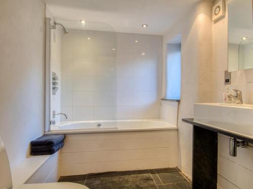 a bathroom with a tub and a sink at 2 Bed in Tiverton oc-77442 in Washfield