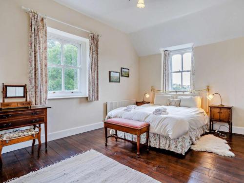 a bedroom with a large bed and a piano at 3 Bed in Brecon oc-bn134 in Brecon