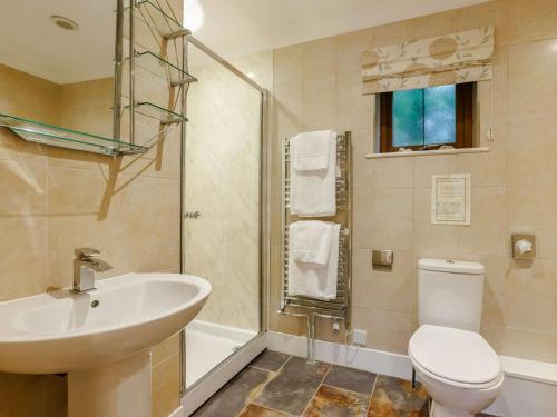 a bathroom with a sink and a toilet and a shower at 3 Bed in Bideford oc-89865 in Westward Ho