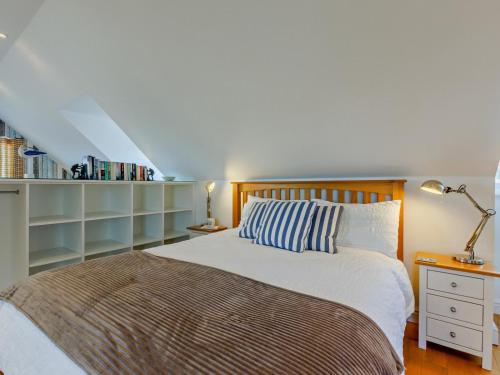 a bedroom with a bed and a book shelf at 1 Bed in Bideford oc-55340 in Instow