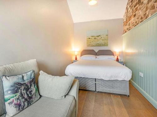 a small bedroom with a bed and a couch at 1 Bed in Umberleigh oc-09090 in Umberleigh Bridge