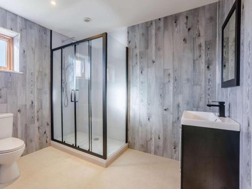 a bathroom with a shower and a toilet and a sink at 3 Bed in Bideford oc-89866 in Westward Ho