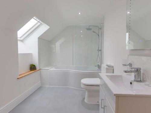 a white bathroom with a toilet and a sink at 5 Bed in Barnstaple oc-85165 in Charles