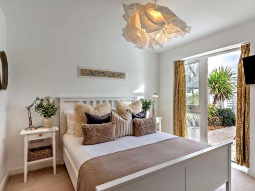 a bedroom with a large bed and a window at 3 Bed in Bideford oc-89018 in Westward Ho