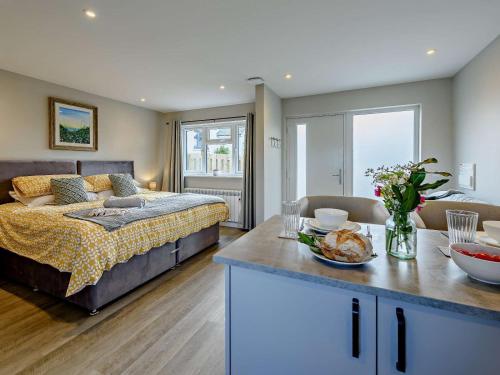 a bedroom with a bed and a table with food on it at 1 Bed in Barnstaple oc-91387 in Marwood