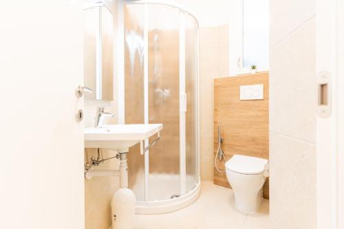 a bathroom with a shower and a sink and a toilet at Tivoli in Bibione