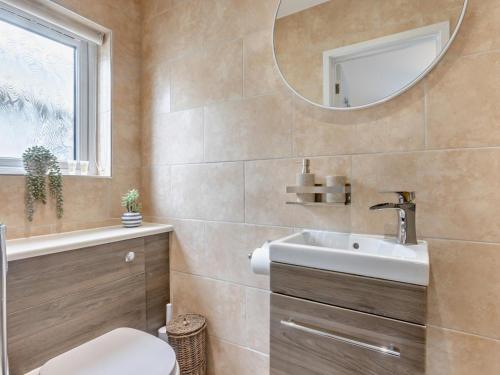 a bathroom with a sink and a mirror at 3 Bed in Bideford oc-64410 in Northam