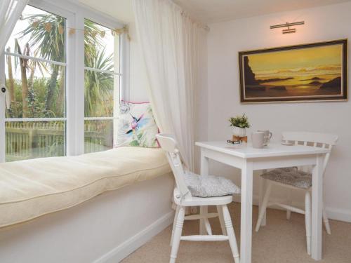 a bedroom with a bed and a desk and a window at 2 Bed in Exeter oc-90455 in Tedburn Saint Mary