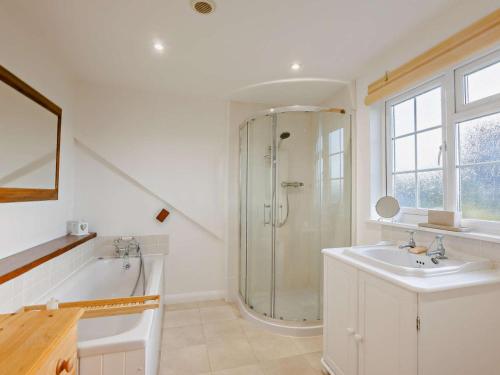 a bathroom with a shower and a sink and a tub at 2 Bed in Exeter oc-90455 in Tedburn Saint Mary