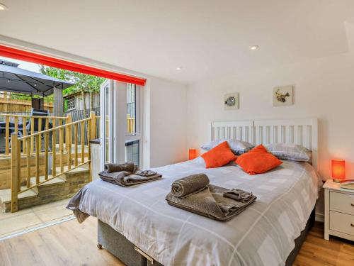 a bedroom with a large bed with towels on it at 5 Bed in Bridport oc-83584 in Charmouth