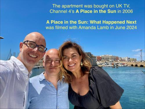 a man and a woman standing next to the water at Palazzo Luceri in Galatina