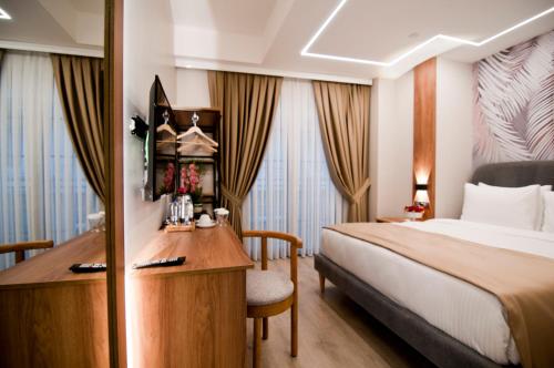 a hotel room with a bed and a desk at Forty Nişantaşı Hotel & SPA in Istanbul